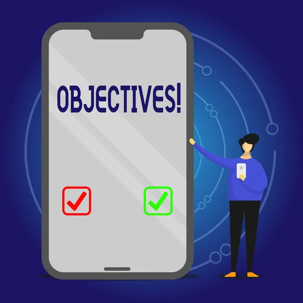 Writing note showing Objectives. Business photo showcasing Goals planned to be achieved Desired targets Company missions Man Presenting Huge Smartphone while Holding Another Mobile. — Stock Photo, Image