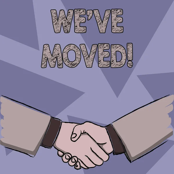 Text sign showing We Ve Moved. Conceptual photo having strong feelings sadness or sympathy has said or done Businessmen Shaking Hands Firmly as Gesture Form of Greeting and Agreement. — Stock Photo, Image