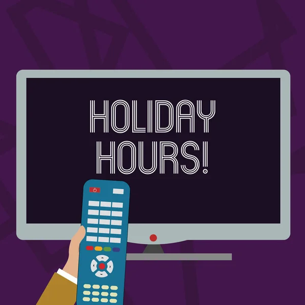 Text sign showing Holiday Hours. Conceptual photo Overtime work on for employees under flexible work schedules Hand Holding Computer Remote Control infront of Blank Wide Color PC Screen.
