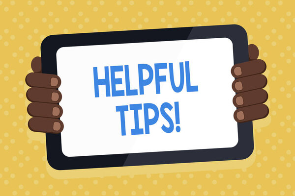 Word writing text Helpful Tips. Business concept for advices given to be helpful knowledge in life Color Tablet Smartphone with Blank Screen Handheld from the Back of Gadget.