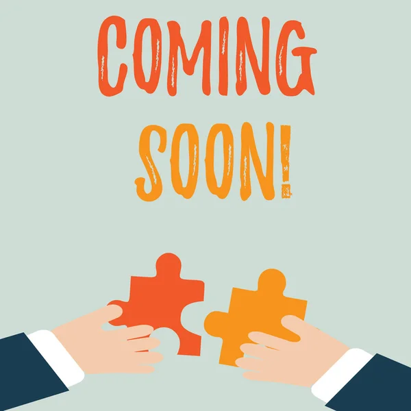 Handwriting text Coming Soon. Concept meaning event or action that will happen after really short time Two Hands Holding Colorful Jigsaw Puzzle Pieces about to Interlock the Tiles. — Stock Photo, Image