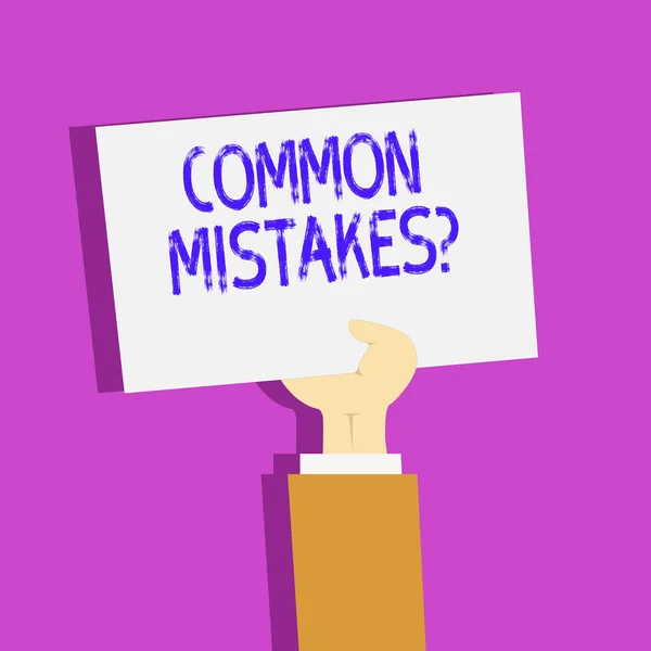 Conceptual hand writing showing Common Mistakes Question. Business photo text repeat act or judgement misguided making something wrong Clipart of Hand Holding Up Sheet of Paper on Pastel Backdrop. — Stock Photo, Image