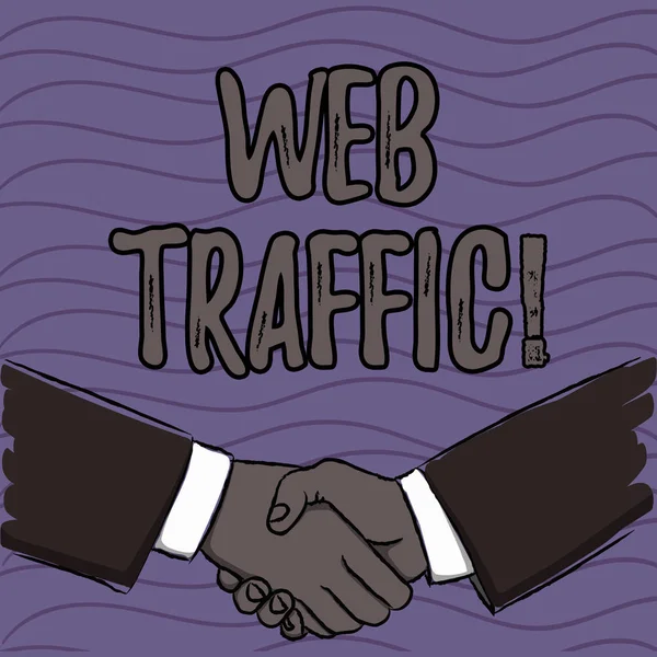 Word writing text Web Traffic. Business concept for amount of data sent and received by visitors to website Businessmen Shaking Hands Firmly as Gesture Form of Greeting and Agreement.