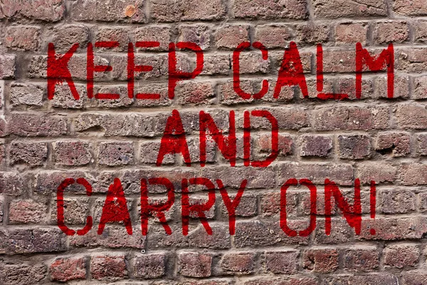 Writing note showing Keep Calm And Carry On. Business photo showcasing slogan calling for persistence face of challenge Brick Wall art like Graffiti motivational call written on the wall.