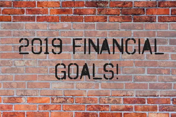 Handwriting text 2019 Financial Goals. Concept meaning New business strategy earn more profits less investment Brick Wall art like Graffiti motivational call written on the wall.