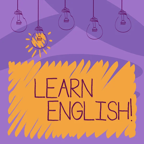 Writing note showing Learn English. Business photo showcasing gain acquire knowledge in new language by study Transparent Bulbs Hanging with Filament and One Lighted Icon.
