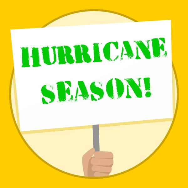 Text sign showing Hurricane Season. Conceptual photo time when most tropical cyclones are expected to develop Hand Holding Blank White Placard Supported by Handle for Social Awareness.