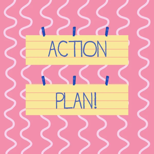 Text sign showing Action Plan. Conceptual photo proposed strategy or course of actions for certain time Two Color Blank Strip Size Lined Paper Sheet Hanging Using Blue Clothespin.