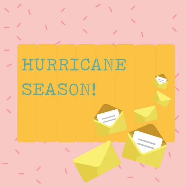 Text sign showing Hurricane Season. Conceptual photo time when most tropical cyclones are expected to develop Closed and Open Envelopes with Letter Tucked In on Top of Color Stationery.