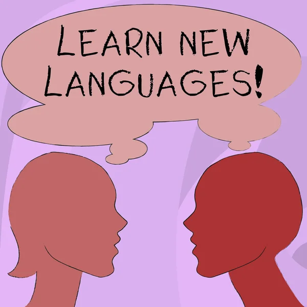 Text sign showing Learn New Languages. Conceptual photo developing ability to communicate in foreign lang Silhouette Sideview Profile Image of Man and Woman with Shared Thought Bubble.