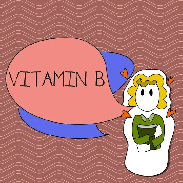 Slovo psaní textu vitaminu B. obchodní koncept pro velmi důležité zdroje a výhody takovou folátu dívka drží knihu s malými srdce kolem ní a dvou barevných bublin. — Stock fotografie