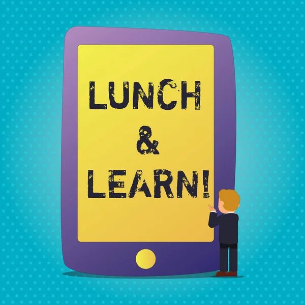 Word writing text Lunch And Learn. Business concept for defiend as seminar offered during free lunch to test it Businessman Standing and Gesturing Facing Blank Screen Giant Tablet Device.