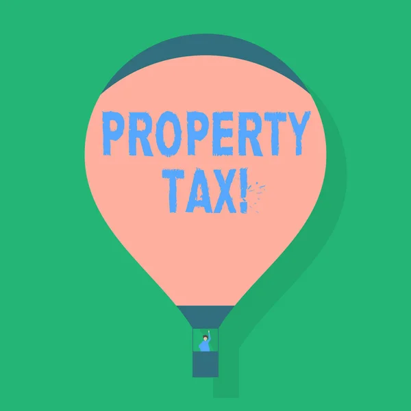 Word writing text Property Tax. Business concept for bills levied directly on your property by government Blank Pink Hot Air Balloon Floating with One Passenger Waving From Gondola.