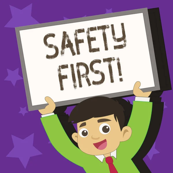 Conceptual hand writing showing Safety First. Business photo text best avoid any unnecessary risks and act so that you stay safe Young Student Raising Upward Frame Whiteboard Above his Head.