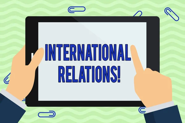 Writing note showing International Relations. Business photo showcasing way in which two or more nations interact with Hand Holding Pointing Touching Color Tablet White Screen.