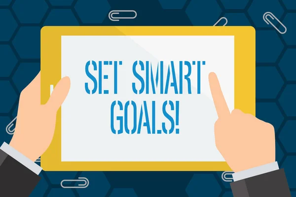 Conceptual hand writing showing Set Smart Goals. Business photo showcasing list to clarify your ideas focus efforts use time wisely Businessman Hand Holding and Pointing Colorful Tablet Screen.