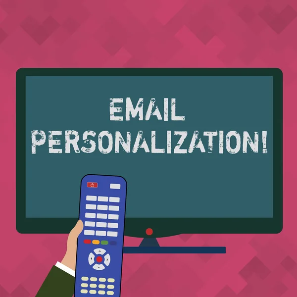 Word writing text Email Personalization. Business concept for allows to insert demonstratingal data into the email template Hand Holding Computer Remote Control infront of Blank Wide Color PC Screen.