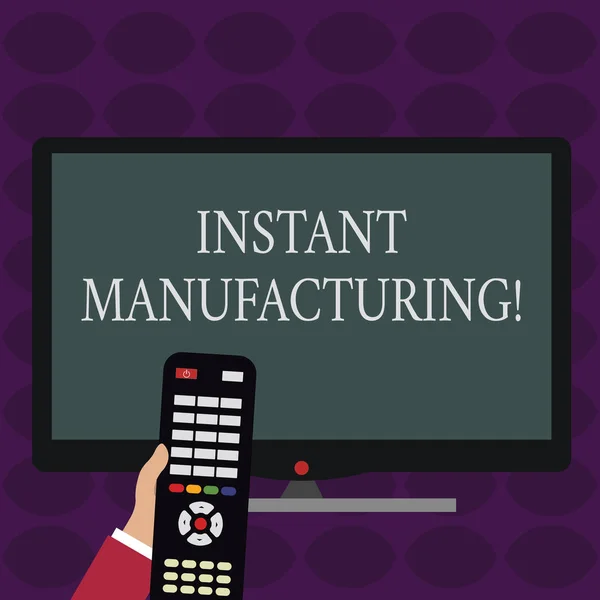 Handwriting text writing Instant Manufacturing. Concept meaning Machines that make products directly from digital file Hand Holding Computer Remote Control infront of Blank Wide Color PC Screen. — Stock Photo, Image