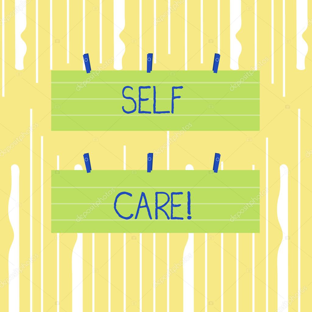 Word writing text Self Care. Business concept for practice of taking action to preserve or improve ones own health Two Color Blank Strip Size Lined Paper Sheet Hanging Using Blue Clothespin.