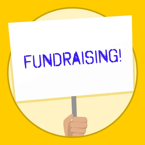 Text sign showing Fundraising. Conceptual photo seeking to generate financial support for charity or cause Hand Holding Blank White Placard Supported by Handle for Social Awareness.