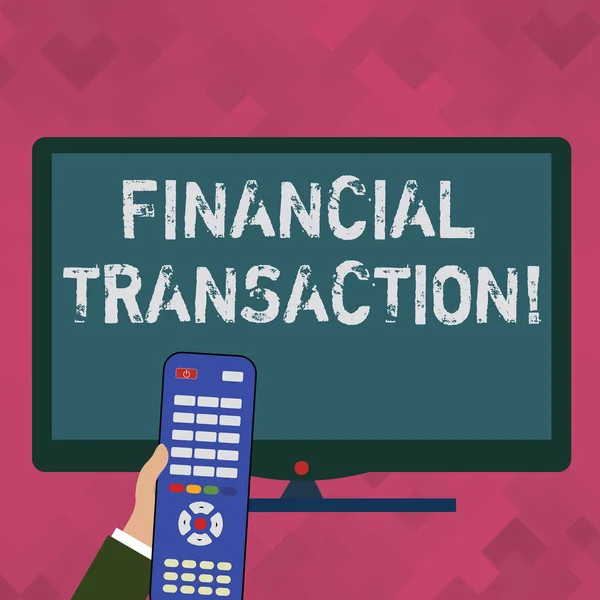 Word writing text Financial Transaction. Business concept for Transactions in financial assets and liabilities Hand Holding Computer Remote Control infront of Blank Wide Color PC Screen.