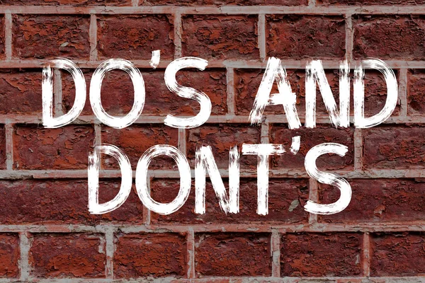 Text sign showing Do S Is And Dont S Is. Conceptual photo advising Rules or customs concerning some activity Brick Wall art like Graffiti motivational call written on the wall. — ストック写真