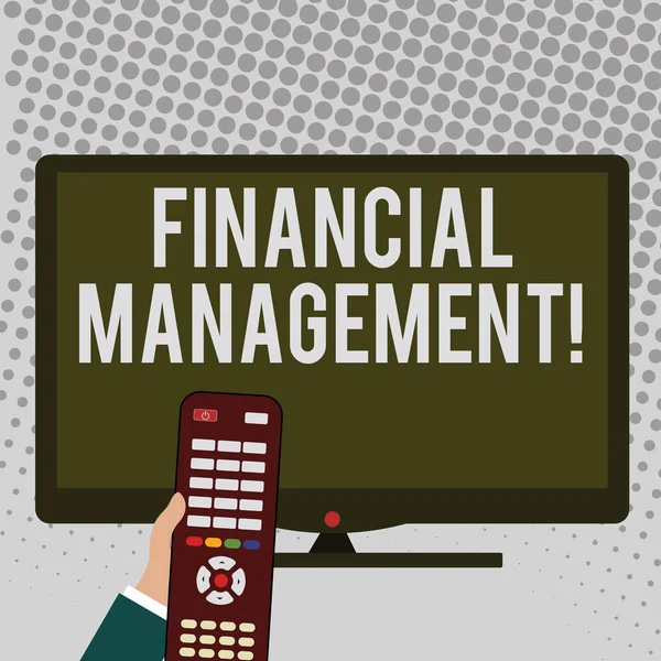 Handwriting text writing Financial Management. Concept meaning controlling and monitoring financial resources Hand Holding Computer Remote Control infront of Blank Wide Color PC Screen.
