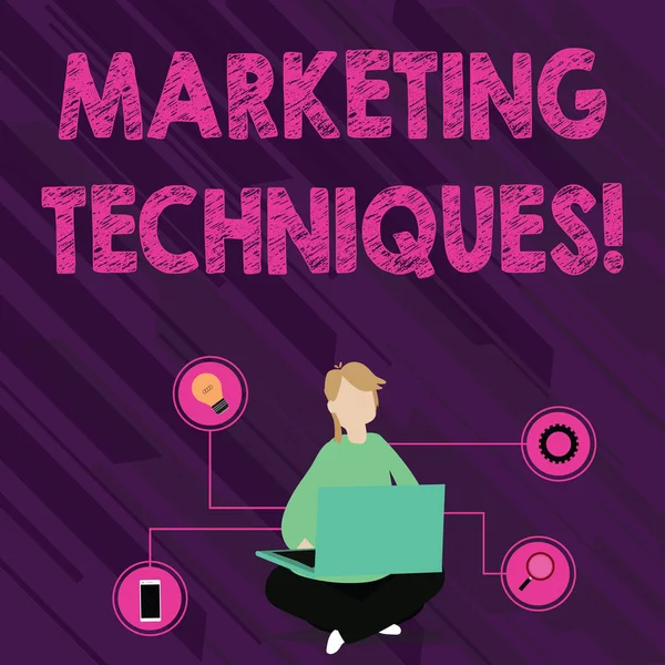 Text sign showing Marketing Techniques. Conceptual photo business s is overall game plan for reaching showing Woman Sitting Crossed Legs on Floor Browsing the Laptop with Technical Icons. — Stok fotoğraf