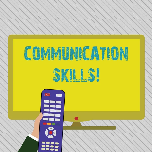 Text sign showing Communication Skills. Conceptual photo ability to convey information to another effectively Hand Holding Computer Remote Control infront of Blank Wide Color PC Screen. — Stock Photo, Image