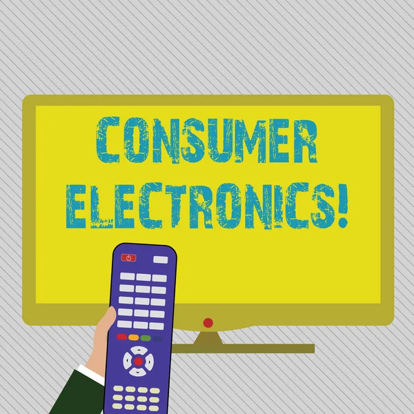 Text sign showing Consumer Electronics. Conceptual photo consumers for daily and noncommercial purposes Hand Holding Computer Remote Control infront of Blank Wide Color PC Screen.