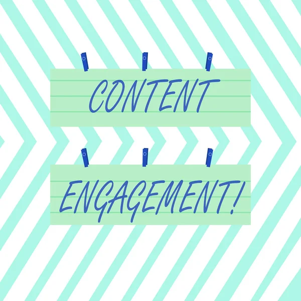 Word writing text Content Engagement. Business concept for action a user takes on a given piece of content Two Color Blank Strip Size Lined Paper Sheet Hanging Using Blue Clothespin.