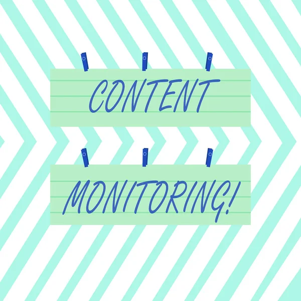 Word writing text Content Monitoring. Business concept for a tool to identify mentions of their organization Two Color Blank Strip Size Lined Paper Sheet Hanging Using Blue Clothespin.