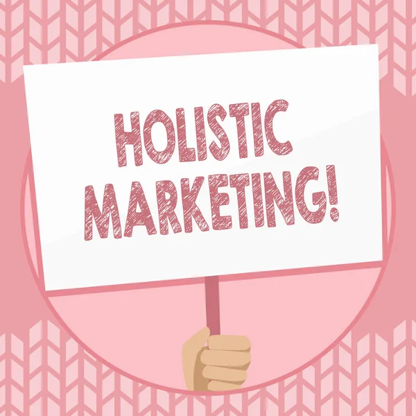 Writing note showing Holistic Marketing. Business photo showcasing developed by thinking about the business as a whole Hand Holding Placard Supported by Handle Social Awareness.