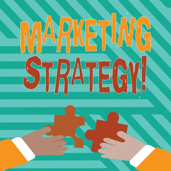 Conceptual hand writing showing Marketing Strategy. Business photo text plan of action designed to promote and sell a product Hands Holding Jigsaw Puzzle Pieces about Interlock the Tiles. — 图库照片