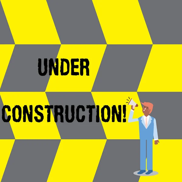 Text sign showing Under Construction. Conceptual photo project that is unfinished but actively being worked on Businessman Looking Up, Holding and Talking on Megaphone with Volume Icon. — Stock Photo, Image