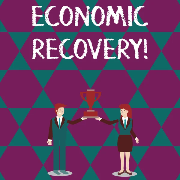 Text sign showing Economic Recovery. Conceptual photo rise of business activity signaling the end of a recession Man and Woman in Business Suit Holding Together the Championship Trophy Cup. — Stock Photo, Image