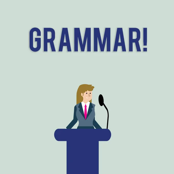 Text sign showing Grammar. Conceptual photo whole system structure language syntax and morphology Businesswoman Standing Behind Podium Rostrum Speaking on Wireless Microphone.