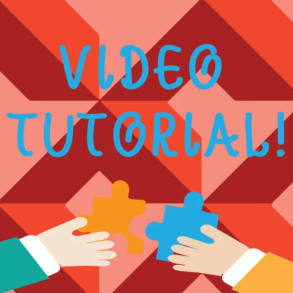 Word writing text Video Tutorial. Business concept for method of transferring knowledge through audiovisual clips Two Hands Holding Colorful Jigsaw Puzzle Pieces about to Interlock the Tiles. — Stock Photo, Image