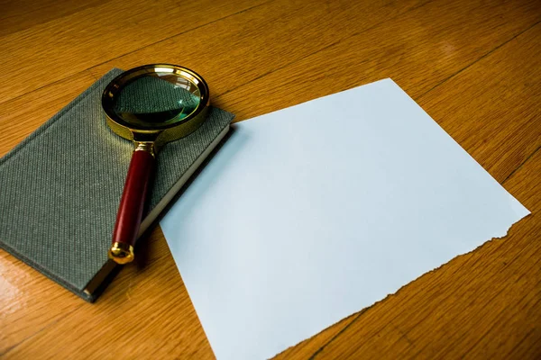 Close up Tablet Gadget and Magnifying Glass on Top of Open Notes, Resting on Wooden Table at the Right Edge, with Copy Space on Left Side for Texts. — Stock Photo, Image