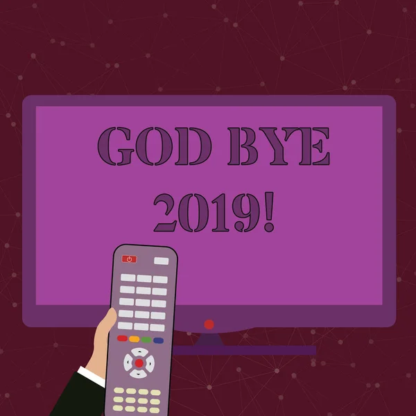 Handwriting text God Bye 2019. Concept meaning express good wishes when parting or at the end of last year Hand Holding Computer Remote Control infront of Blank Wide Color PC Screen.