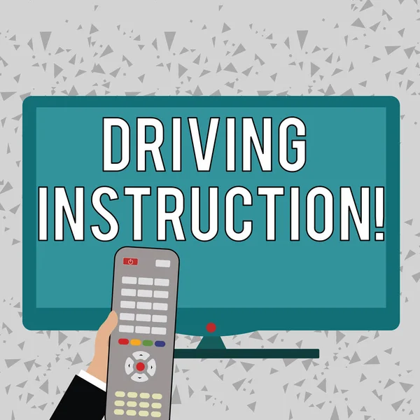 Word writing text Driving Instruction. Business concept for detailed information on how driving should be done Hand Holding Computer Remote Control infront of Blank Wide Color PC Screen.
