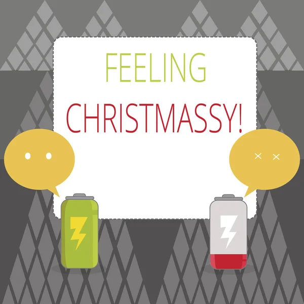 Text sign showing Feeling Christmassy. Conceptual photo Resembling or having feelings of Christmas festivity Fully Charged and Discharged Battery with Two Colorful Emoji Speech Bubble.