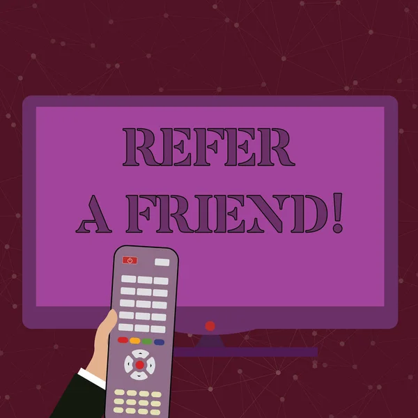 Handwriting text Refer A Friend. Concept meaning direct someone to another or send him something like gift Hand Holding Computer Remote Control infront of Blank Wide Color PC Screen.