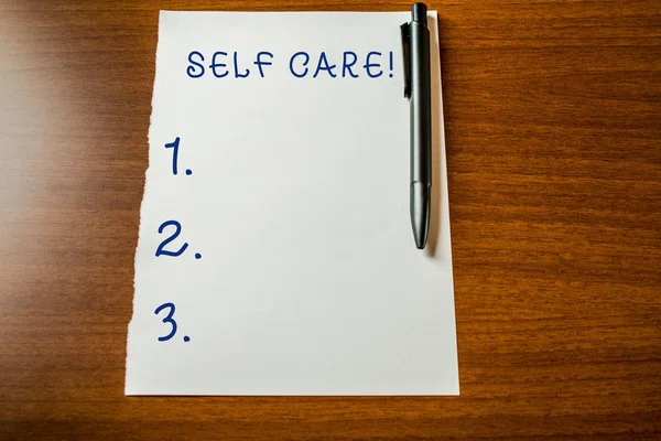 Handwriting text Self Care. Concept meaning practice of taking action to preserve or improve ones own health Upper view blank stationary paper lying wooden table pen. Writing essay. — Stock Photo, Image