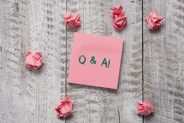 Writing note showing Q And A. Business photo showcasing defined as questions being asked and answers Thick set of plain note paper with scraps on the wooden textured table. — 스톡 사진