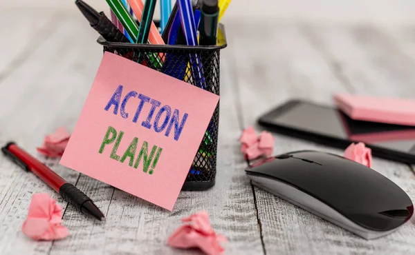 Word writing text action plan. Business-Konzept für vorgeschlagene Strategie oder Vorgehensweise für bestimmte Zeit Schreibgeräte und Papier plus Fetzen mit Gadgets auf dem Holztisch. — Stockfoto
