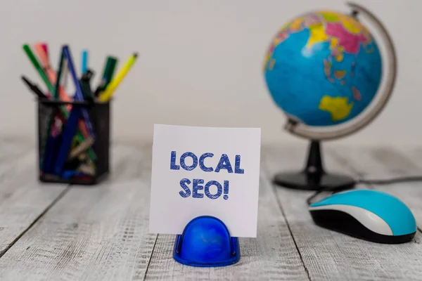 Conceptual hand writing showing Local Seo. Business photo showcasing incredibly effective way to market your near business online Stationary and computer mouse with globe on the wooden desk. — Stock Photo, Image