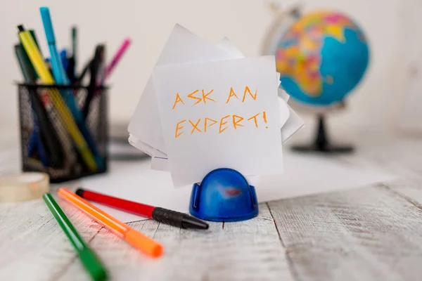 Text sign showing Ask An Expert. Conceptual photo confirmation that have read understand and agree with guidelines Stationary plus pens and papers with artificial globe on the wooden desk. — Stock Photo, Image