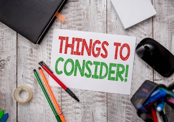 Writing note showing Things To Consider. Business photo showcasing think about something carefully in order to make decision Stationary and computer stuff pen with paper sheets on desk. — Stock Photo, Image