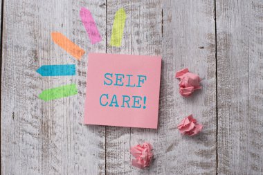Word writing text Self Care. Business concept for practice of taking action to preserve or improve ones own health Plain note paper and line arrow stickers on the top of wooden table desk.